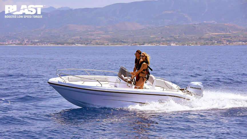 side view of couple steering boat powered by a honda outboard motor with honda blast technology