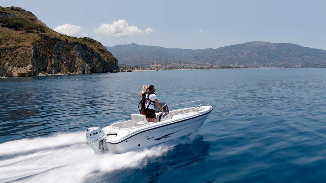 Couple in a BF 40 driven boat at speed in a lake