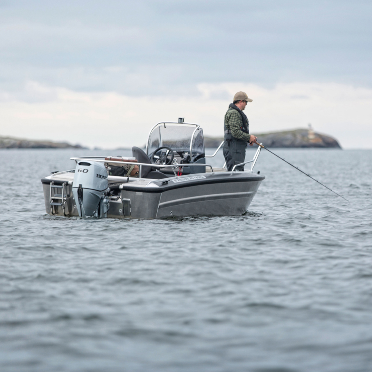 Gentleman fishing on a boat with Honda BF60 engine.