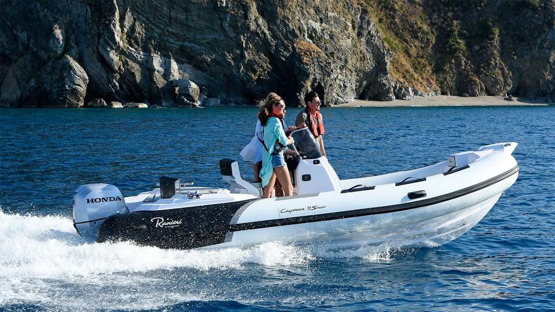 side view of a couple on a ranieri sports boat fitted with a honda marine engine
