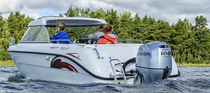 rear angled of people on a boat powered by a 100 horsepower marine engine