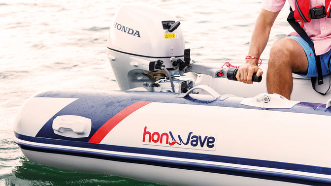 side view of honwave inflatable boat with honda engine on water