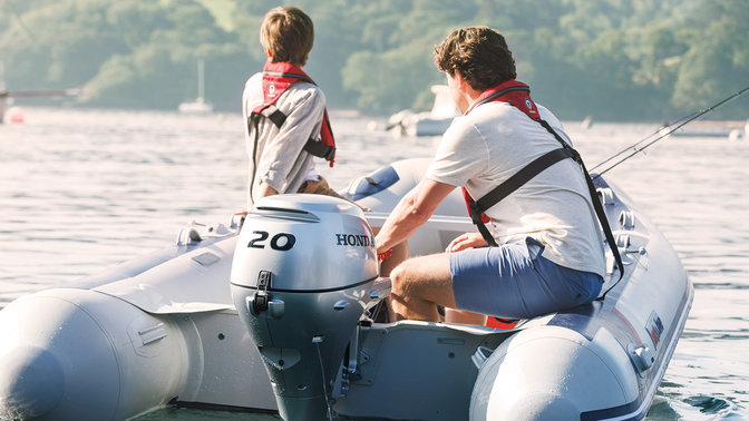 rear view of people steering a honwave inflatable boat fitted with a honda outboard engine