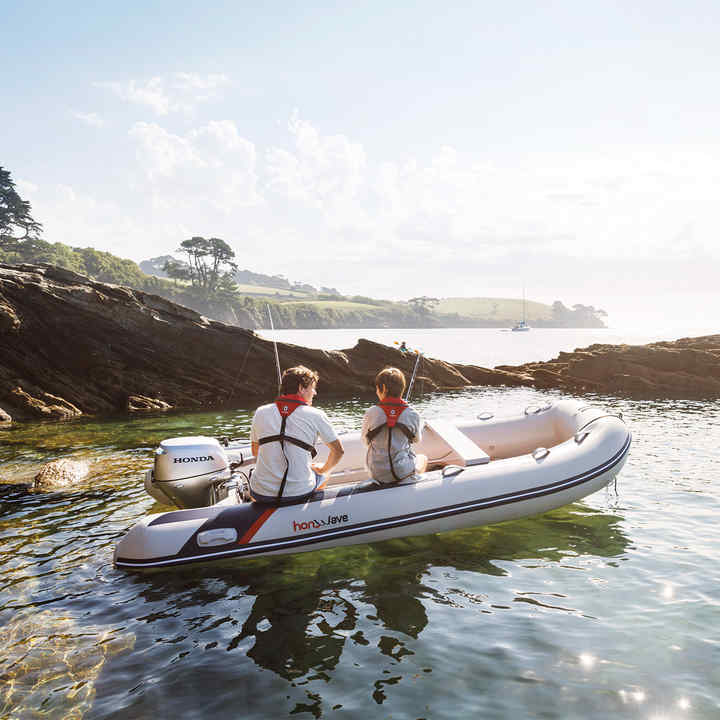 Boat using Honda V6 range engine, being used by models, coastal location.