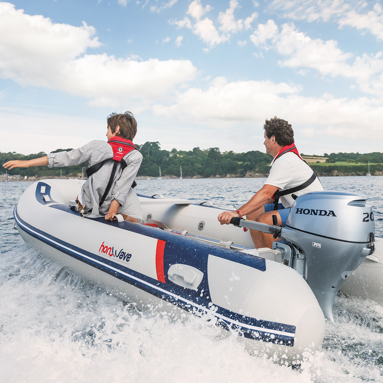 Close up of two people on boat in open water