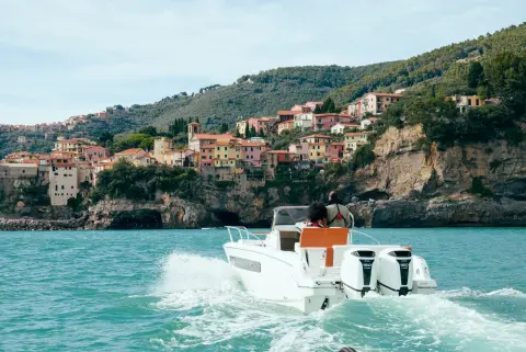 Models in the back of the boat in sea location featuring BF150 L4 engine.