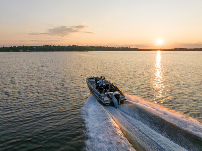 Aerial view of boat steering through the sea.