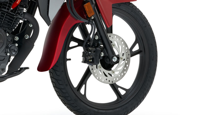 Honda CB125F red studio shot focus on front wheel and brake