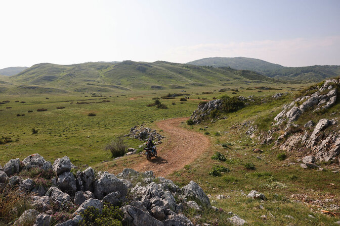 Two HAR riders off-road with mountains in background