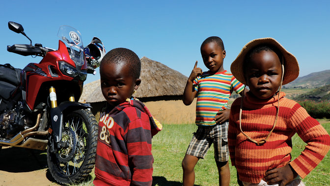 Young children outside gathered around a CRF1000L Africa Twin