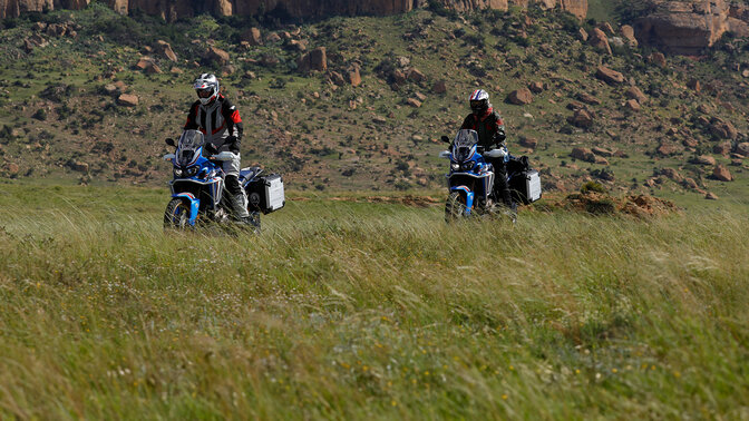 two HAR riders off-road with mountains in background