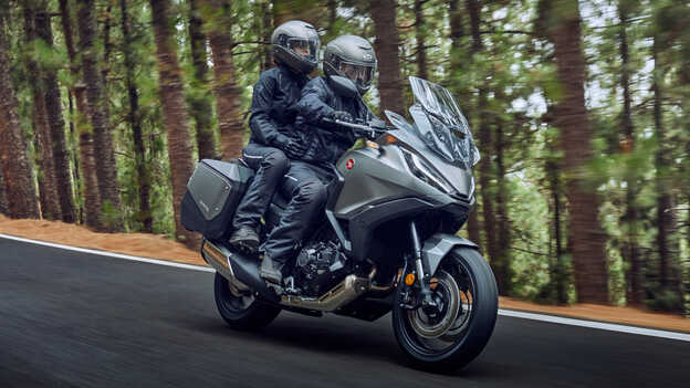 Front facing three quarter Honda NT1100 being ridden through the forest