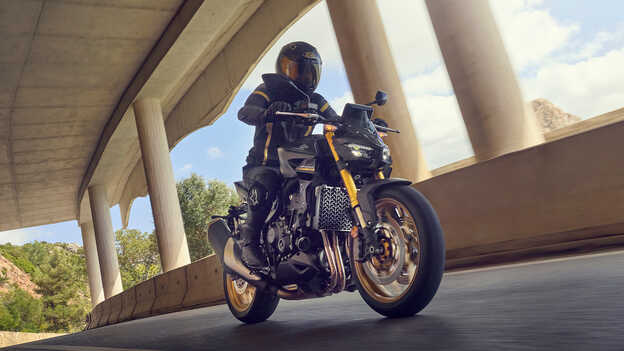 Dax 125 static rear three quarter image by the sea.