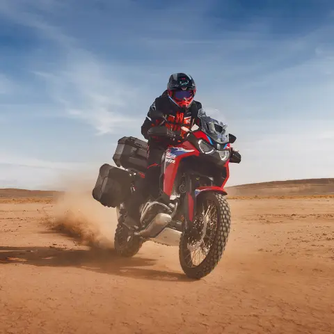 Rider on Honda CRF1100 Africa Twin Adventure Sport in desert location.