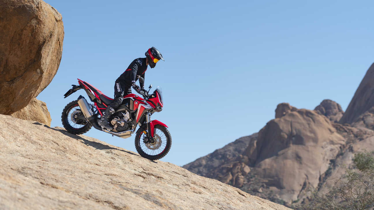 Honda Africa Twin, right side, riding down a rock