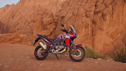 CRF1100L Africa twin motorbike parked in a desert location.