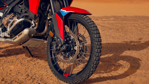 Close up of wheels on a CRF1100L Africa Twin bike in a desert location.