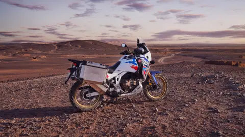 Rider on Honda CRF1100 Africa Twin Adventure Sports in desert location.