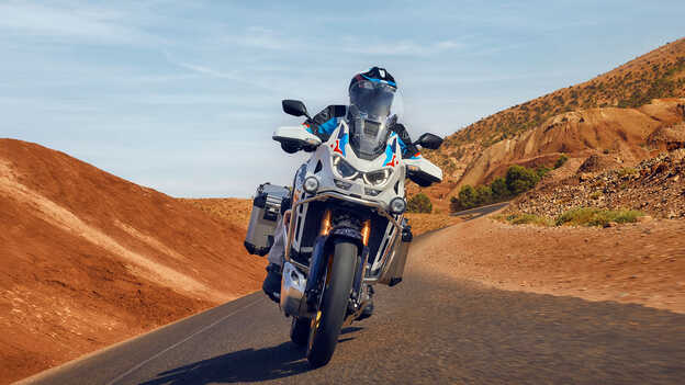 Rider on Honda CRF1100 Africa Twin Adventure Sports in desert location.