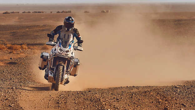 front facing rider on Honda CRF1100 Africa Twin Adventure Sports in desert location.