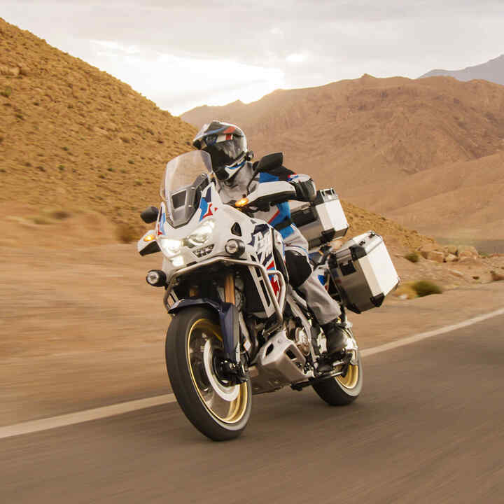 Rider on Honda CRF1100 Africa Twin Adventure Sports in desert location.