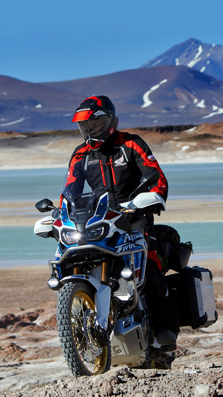Front three-quarter facing Honda Africa Twin Adventure Sports with driver, mountain location.