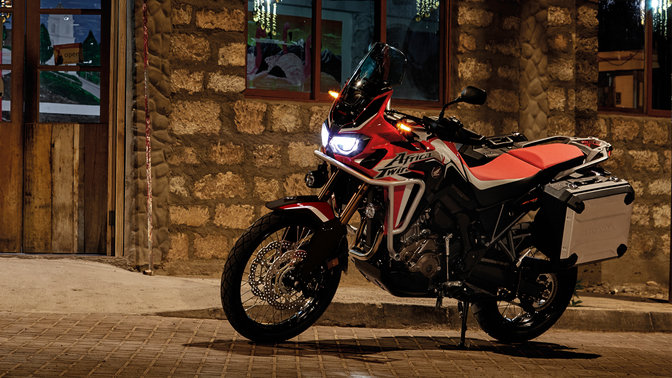 Honda Africa Twin parked outside restaurant.