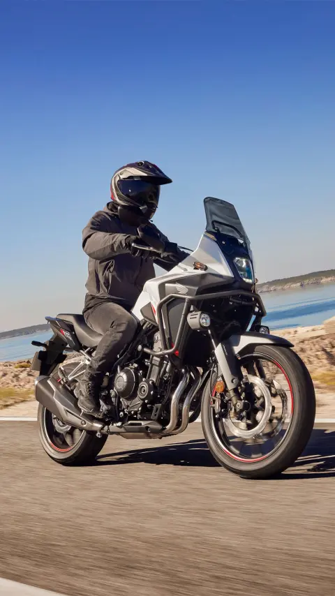 Honda NX500 riding on coastal road