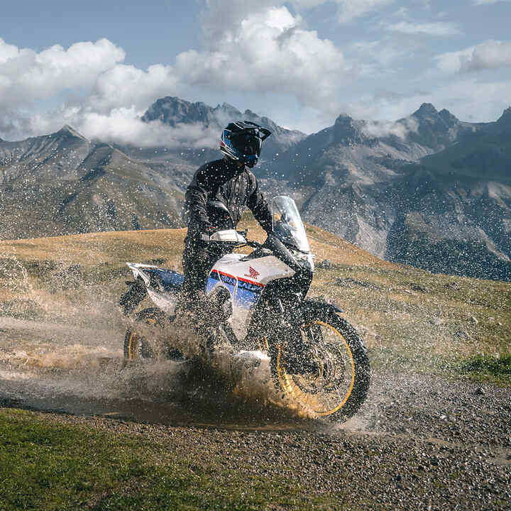 XL750 Transalp riding through water off-road.