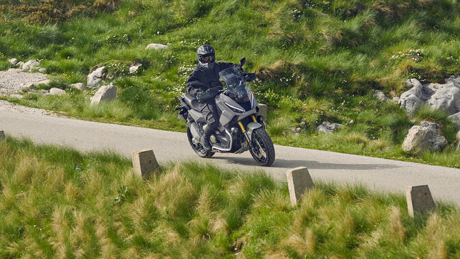 Rider on Honda X-ADV in a mountain location.