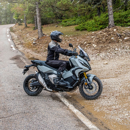 Honda X-ADV, right side, with rider, grey bike, forest track