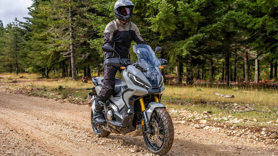 Honda X-ADV - 3-quarter front right ride, with rider, forest road