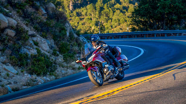 Gold Wing Tour dynamic side on shot with rider and pillion