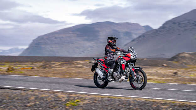 Africa Twin front three quarter with rider on road