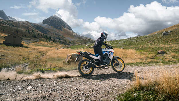 Transalp dynamic rear shot with rider on gravel