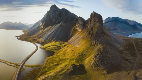 Scenic road in Iceland, beautiful nature landscape aerial panorama, mountains and coast at sunset