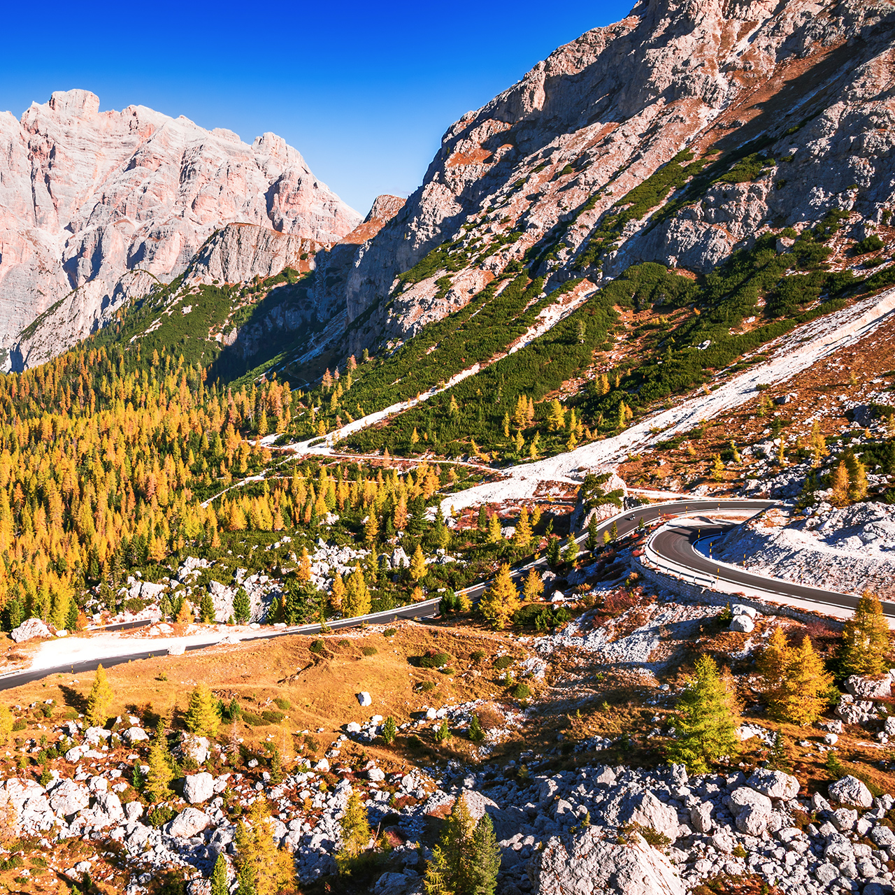 Passo Valparola, Italy. View of the serpentine in the Tyrol, Dolomite Alps. Mountain view Cima Cunturines (3.064 m) from Passo di Valparola with in autumn near Cortina d'Ampezzo, Belluno in Italy
