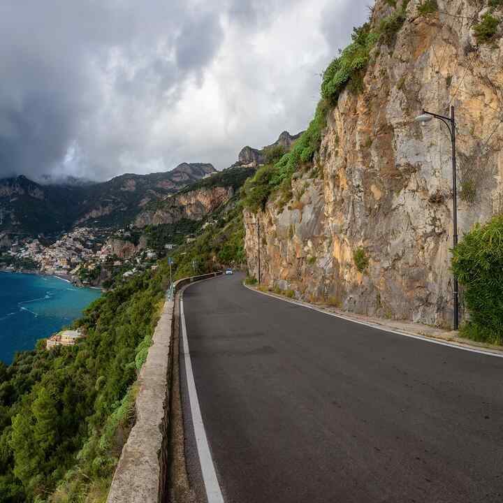 Scenic Road on Rocky Cliffs and Mountain Landscape by the Tyrrhenian Sea. Amalfi Coast, Positano, Italy. Adventure Travel. Panoramic View