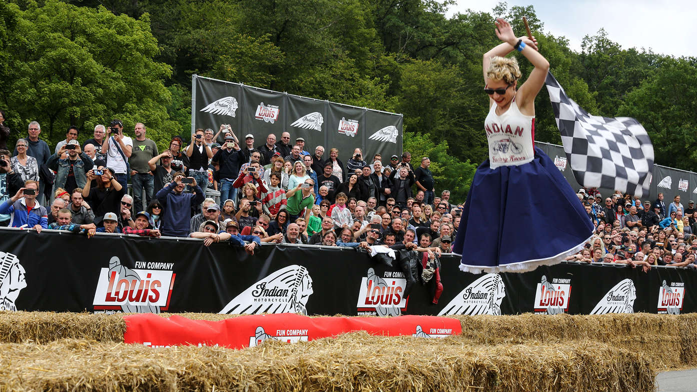 A lady waving the chequered flag.