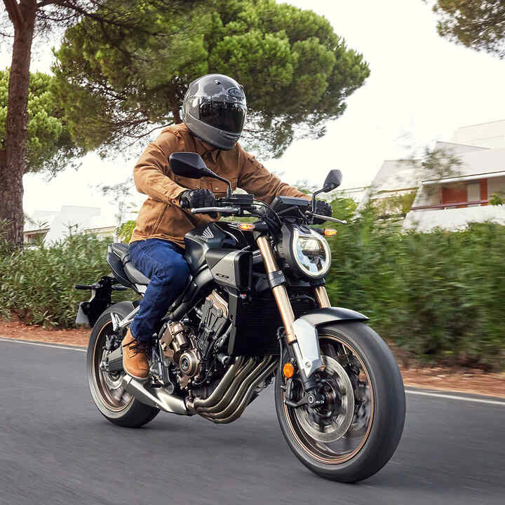 Model riding motorbike in a mountain location.