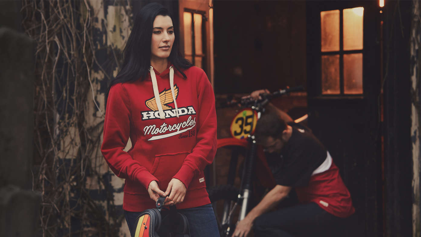 Man and women wearing red vintage Honda hoodie. 