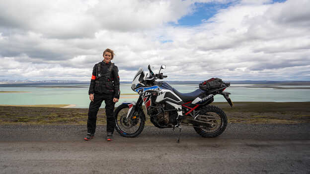 Vanessa Ruck standing next to Africa Twin. 