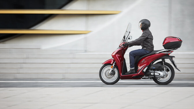 Honda SH125i being ridden on location