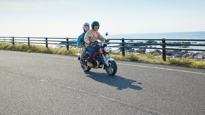 Honda DAX125 on road by the coast