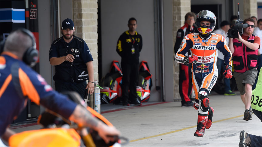 Honda MotoGP racer getting on the bike.