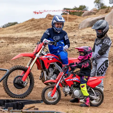 Honda CRF50F and CRF450F on off road circuit