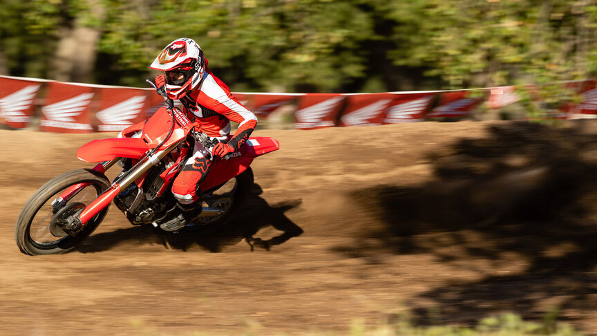 Two riders going over jumps on the Honda CRF450R.