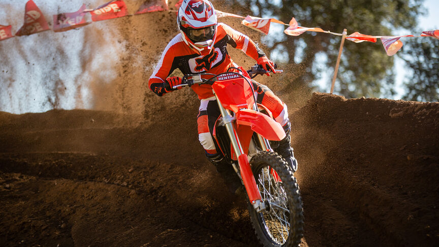 Two riders going over jumps on the Honda CRF450R.
