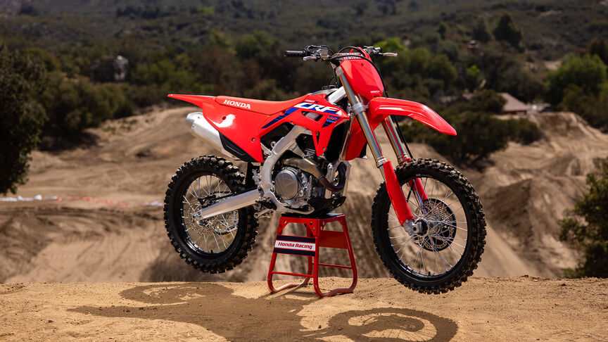 Two riders going over jumps on the Honda CRF450R.