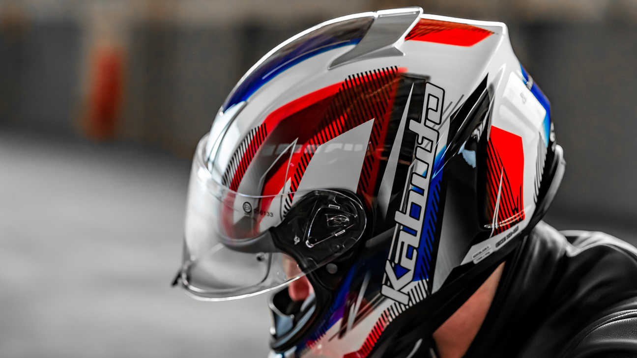 Honda Kabuto helmet, Aeroblade V - Go White Blue Red - CBR650, left side, on the head of a biker
